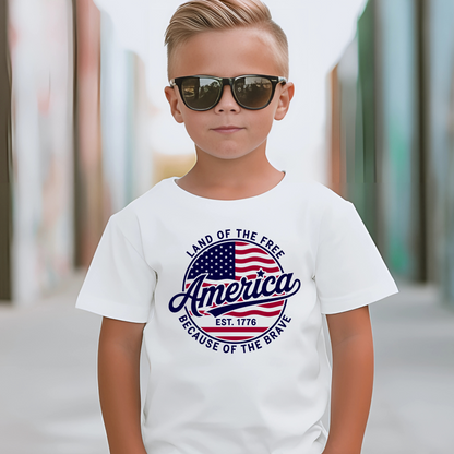 Confident boy in white shirt with sunglasses and patriotic "Land of the Free" graphic