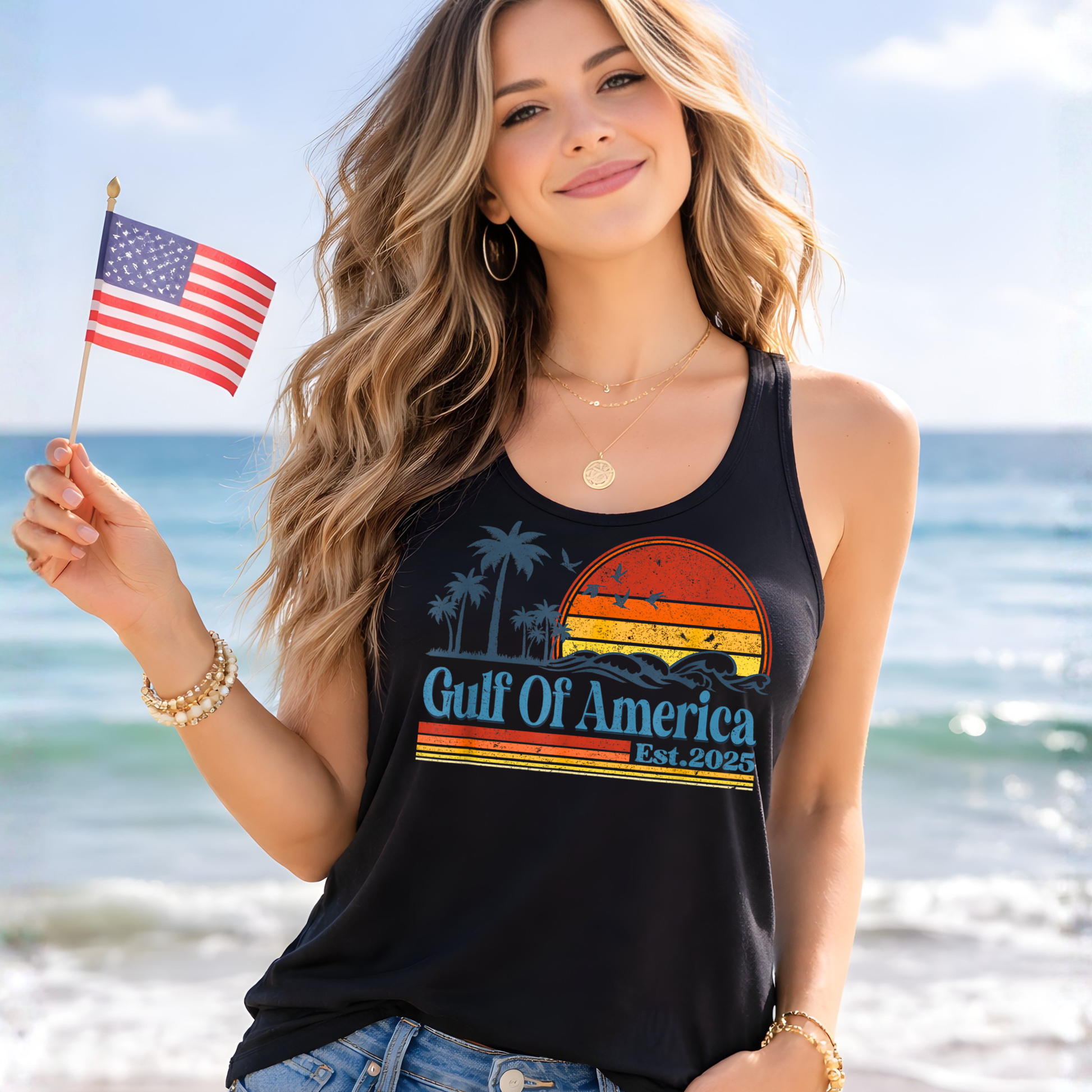 Woman wearing black Gulf of America tank holding American flag, patriotic summer outfit, beach graphic tank top