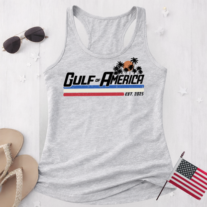 Sports gray women’s racerback tank top flat lay with Gulf of America graphic, styled with sunglasses, sandals and American flag