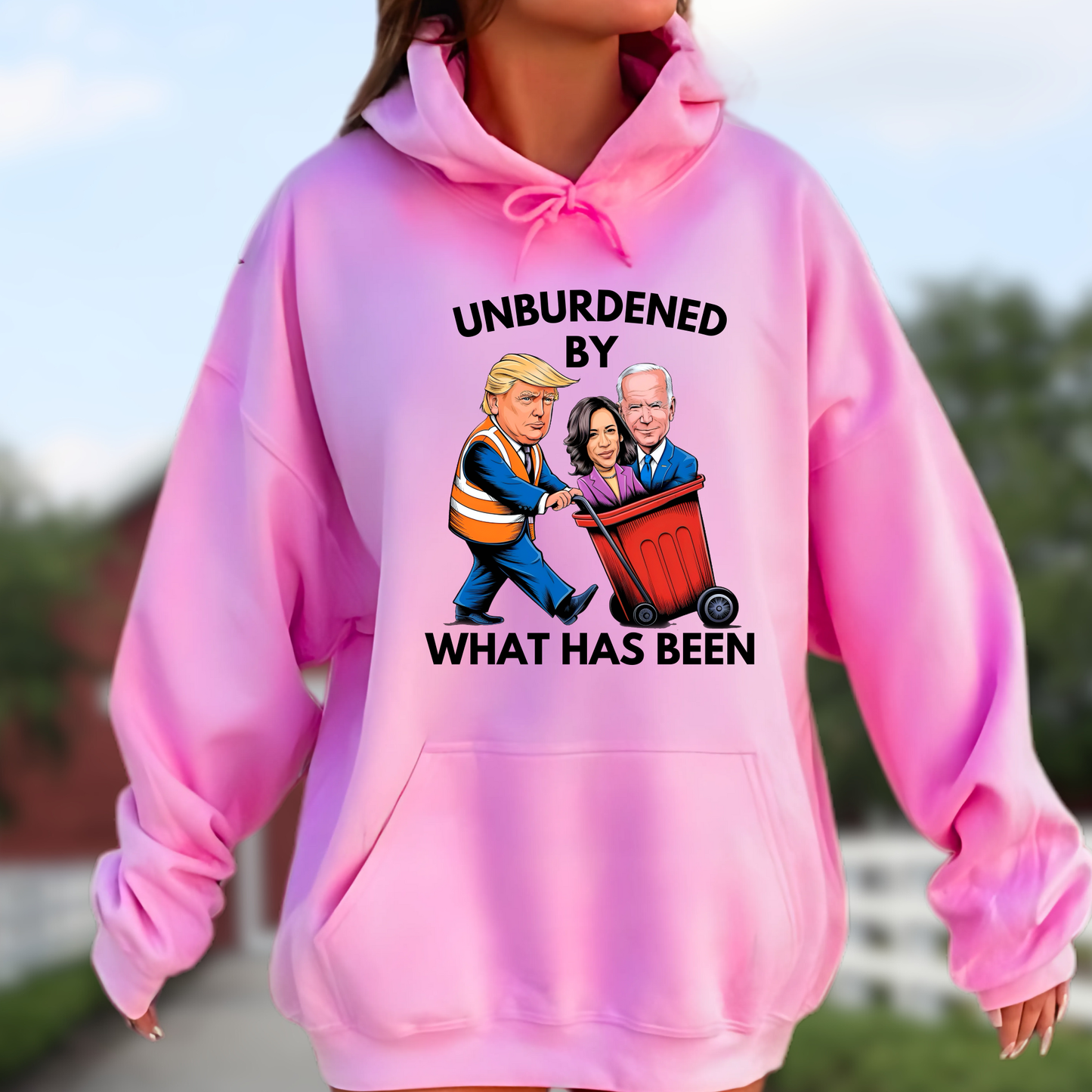 Woman wearing a pink hoodie with cartoon-style parody graphic and bold text.