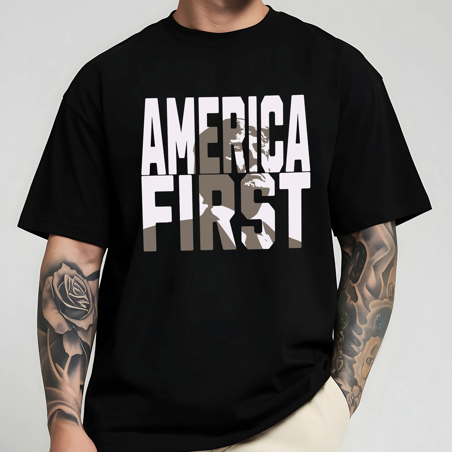 Man wearing black America First graphic tee with tattoo sleeve

