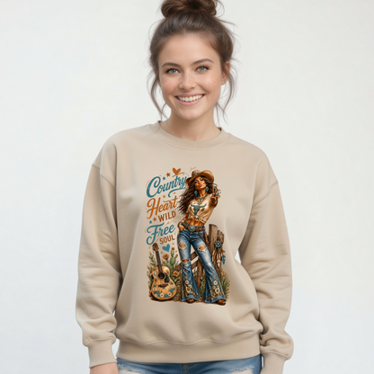 Woman modeling a sand crewneck sweatshirt with the Country Heart Wild Free Soul western cowgirl graphic on a clean studio background.