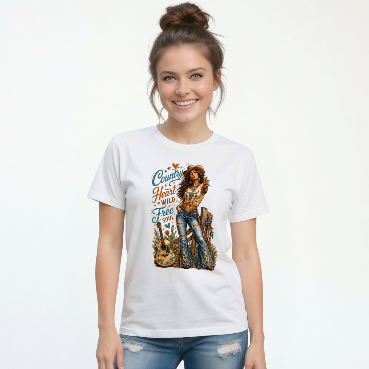 Woman wearing a white T-shirt with the Country Heart Wild Free Soul cowgirl and guitar graphic on a clean studio background.
