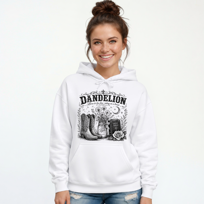 Woman wearing a white Dandelion pullover hoodie with cowboy boots, dandelion-filled mason jar, Holy Bible, rose, and crescent moon graphic on a white background