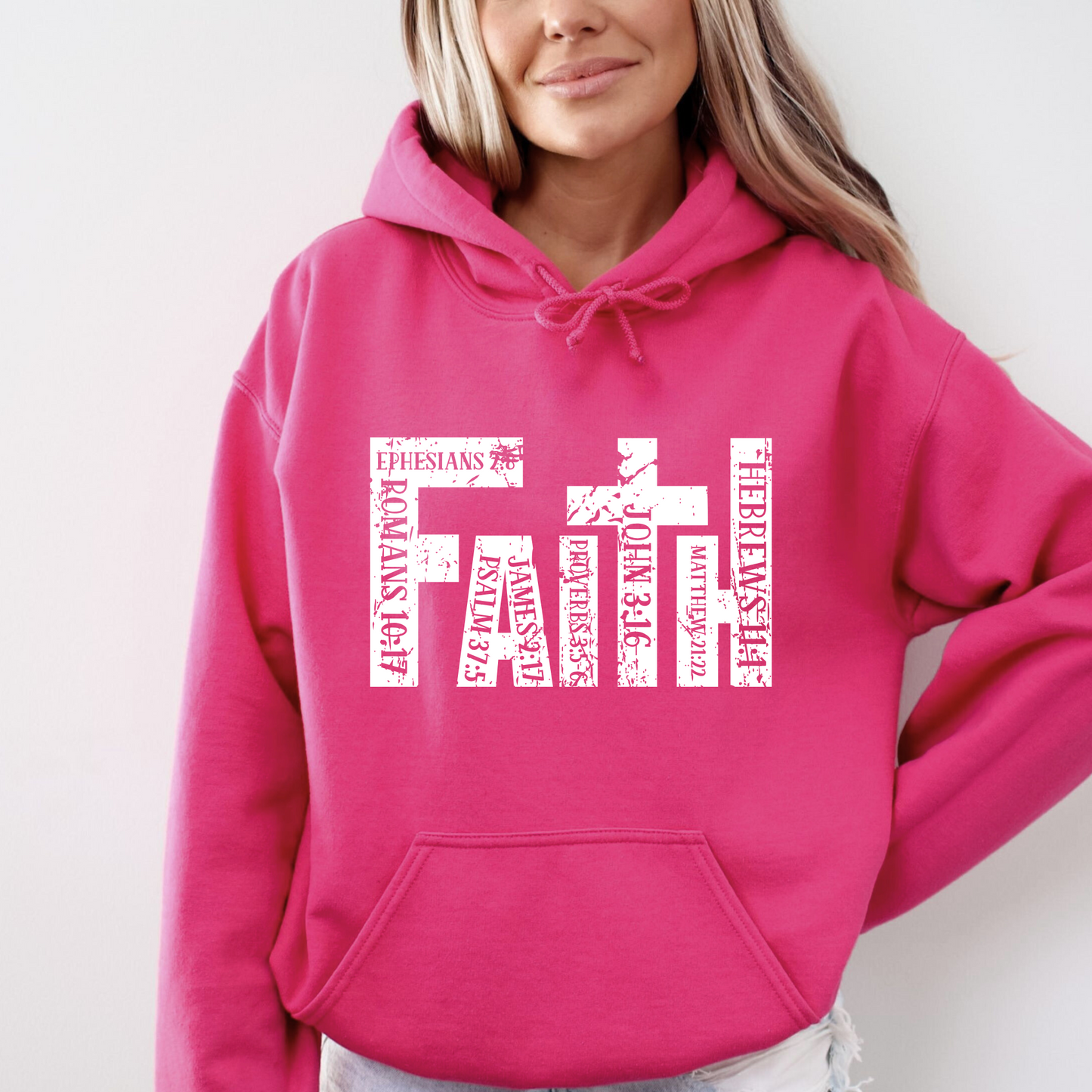 Bright Pink Christian hoodie featuring 'FAITH' in bold distressed white letters, designed with Bible verse references including John 3:16, Romans 10:17, Hebrews 11:1, and more. Inspirational religious sweatshirt for faith-based fashion.