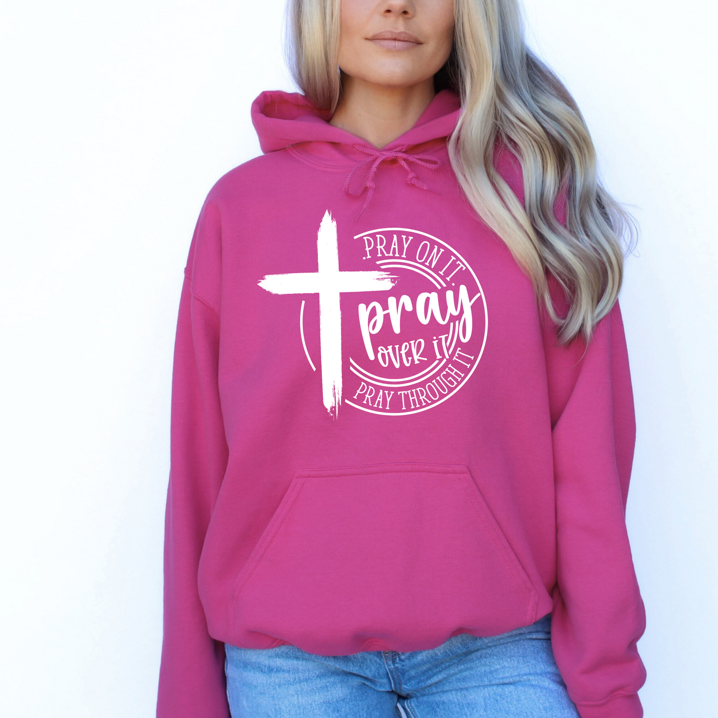 Woman wearing a Dark Pink hoodie with a motivational prayer message and cross symbol.