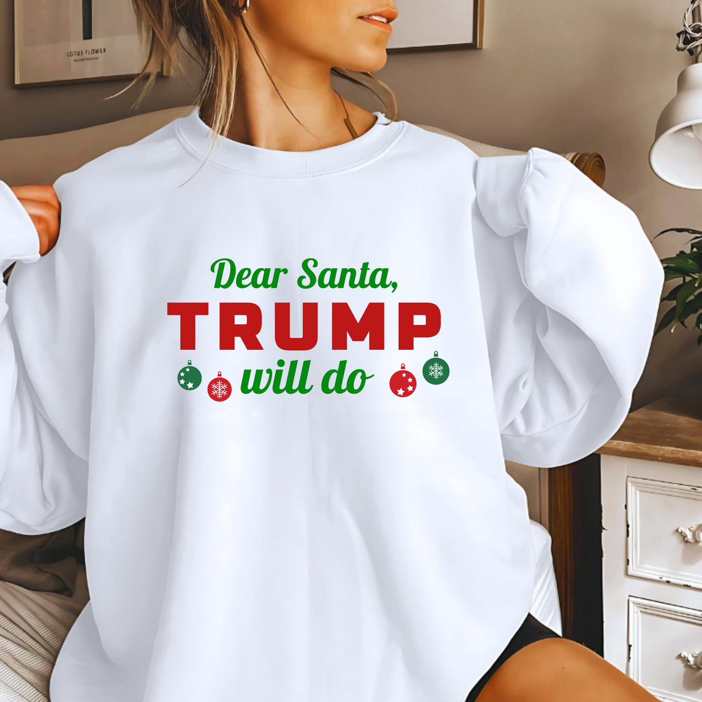 Woman wearing white “Dear Santa, Trump Will Do” Christmas sweatshirt with red and green lettering