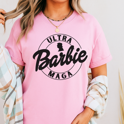Woman wearing light pink Ultra Maga Doll T-shirt with bold circle logo design.