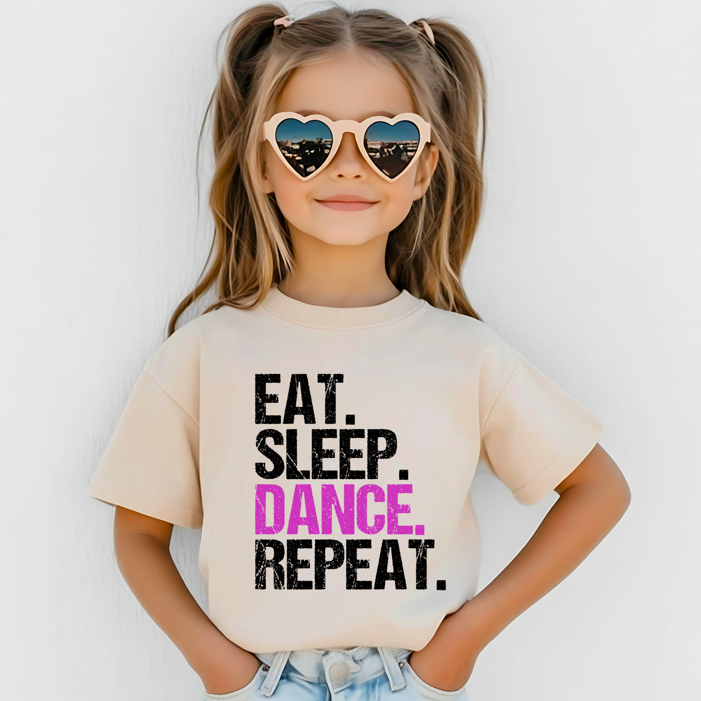 Dance all day in this trendy ‘Eat. Sleep. Dance. Repeat.’ T-shirt! Made for comfort and style, this tee is perfect for hip-hop, ballet, and jazz dancers. A must-have for any dance lover!