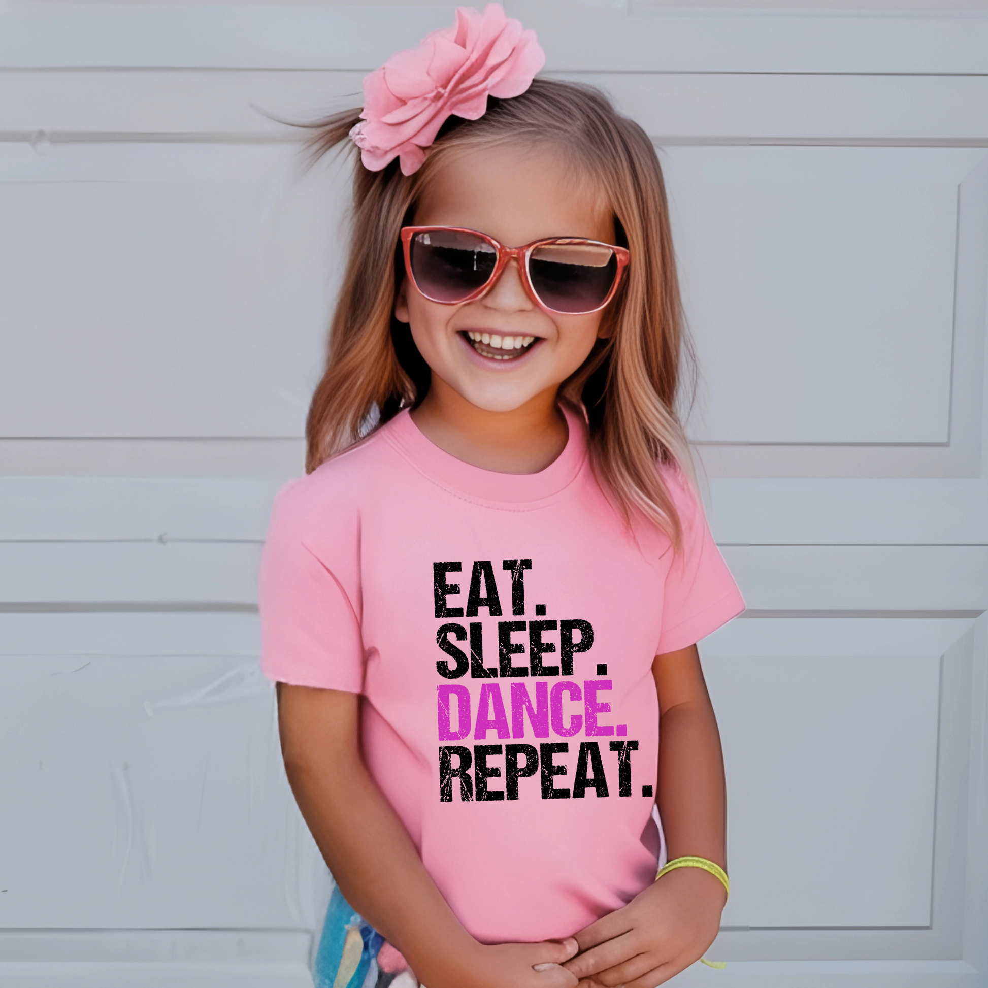Dance all day in this trendy ‘Eat. Sleep. Dance. Repeat.’ T-shirt! Made for comfort and style, this tee is perfect for hip-hop, ballet, and jazz dancers. A must-have for any dance lover!