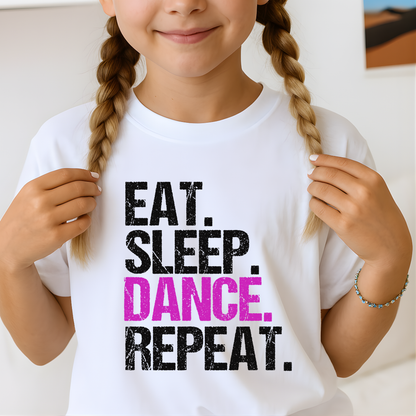 Close-up of youth white dance t-shirt showing distressed “Eat Sleep Dance Repeat” design in black and pink, girls dance practice tee.