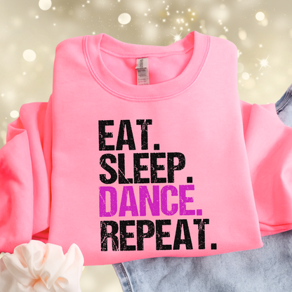 Flat lay bright pink youth sweatshirt with “Eat Sleep Dance Repeat” graphic, cozy girls dance crewneck, cute gift for young dancers.