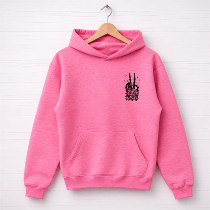 Bright pink hoodie flat lay with a small black floral skeleton peace-sign graphic on the left chest.