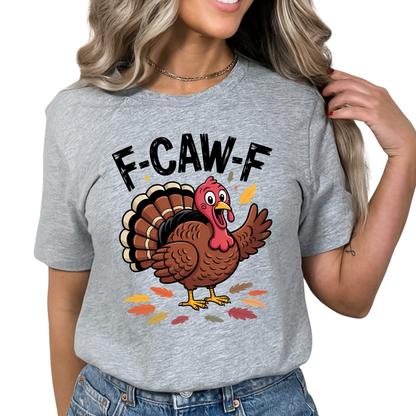 Sports Gray F-CAW-F Turkey Day Humor Shirt – woman wearing gray unisex Thanksgiving graphic tee with cartoon turkey and autumn leaves