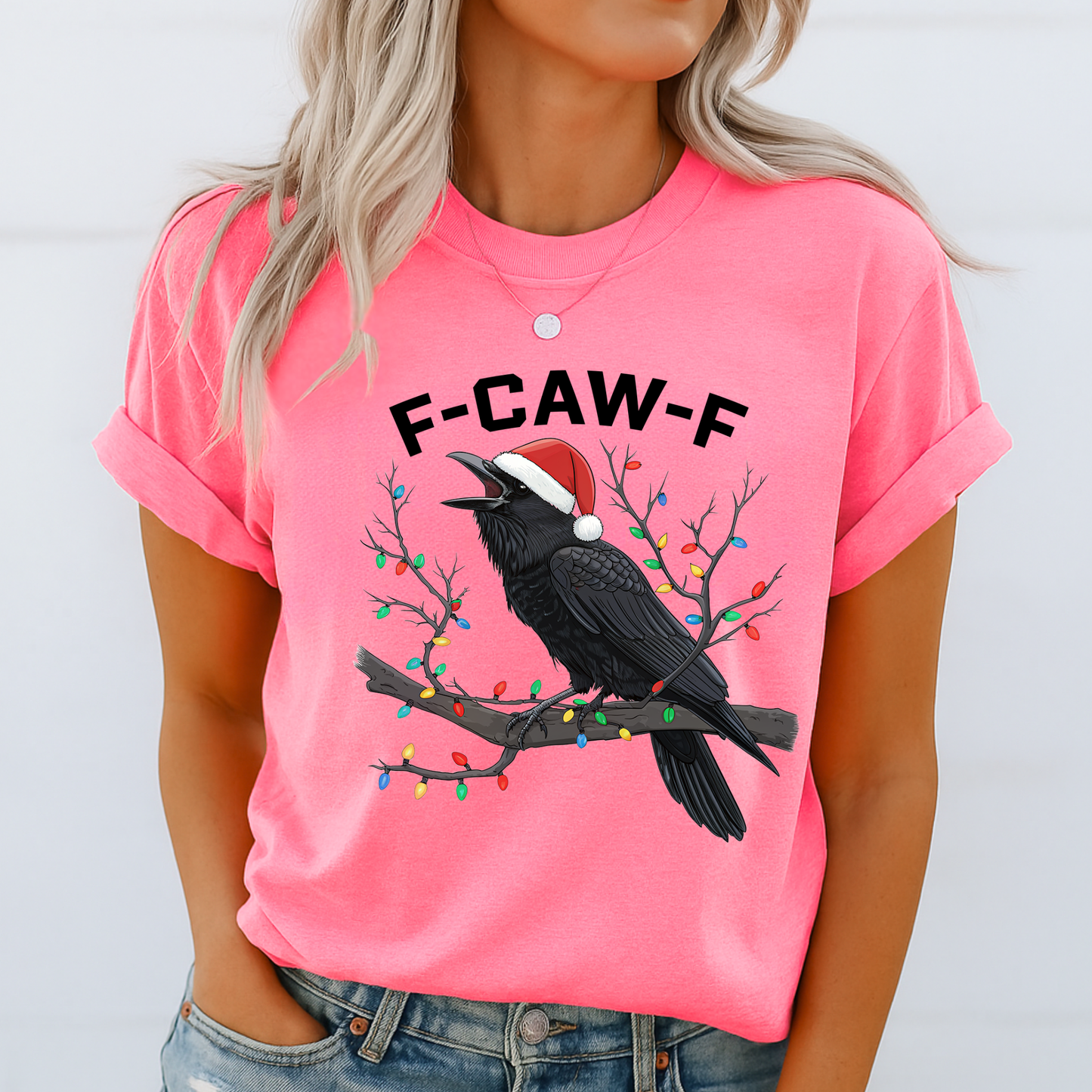 Woman wearing bright pink funny holiday raven t-shirt with F-CAW-F text.