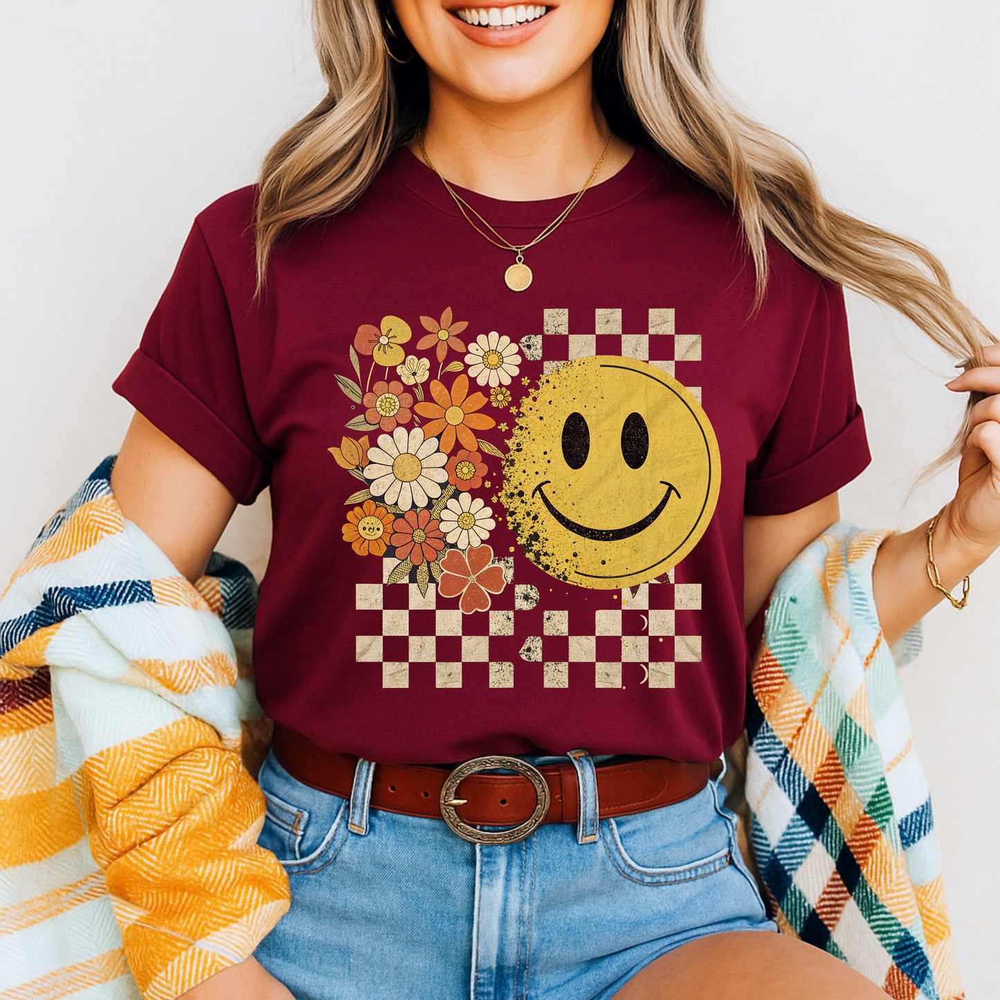 Maroon fall graphic tee with retro smiley face and checkered background

