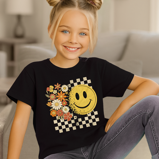 Youth girl wearing fall smiley face t-shirt with floral and checkerboard design
