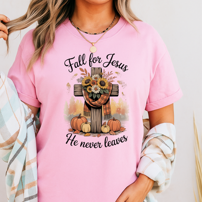 Person wearing a pink t-shirt with 'Fall for Jesus He never leaves' design.