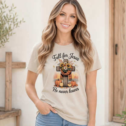 Smiling woman wearing a Sand T-shirt with the Fall for Jesus He Never Leaves cross, pumpkin, and sunflower design.
