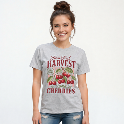 Woman wearing a sports gray T-shirt printed with the retro Farm Fresh Harvest cherries graphic.