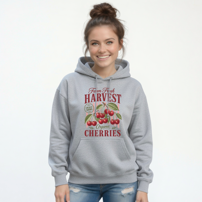 Woman wearing a sports gray pullover hoodie featuring the Farm Fresh Harvest cherries graphic.