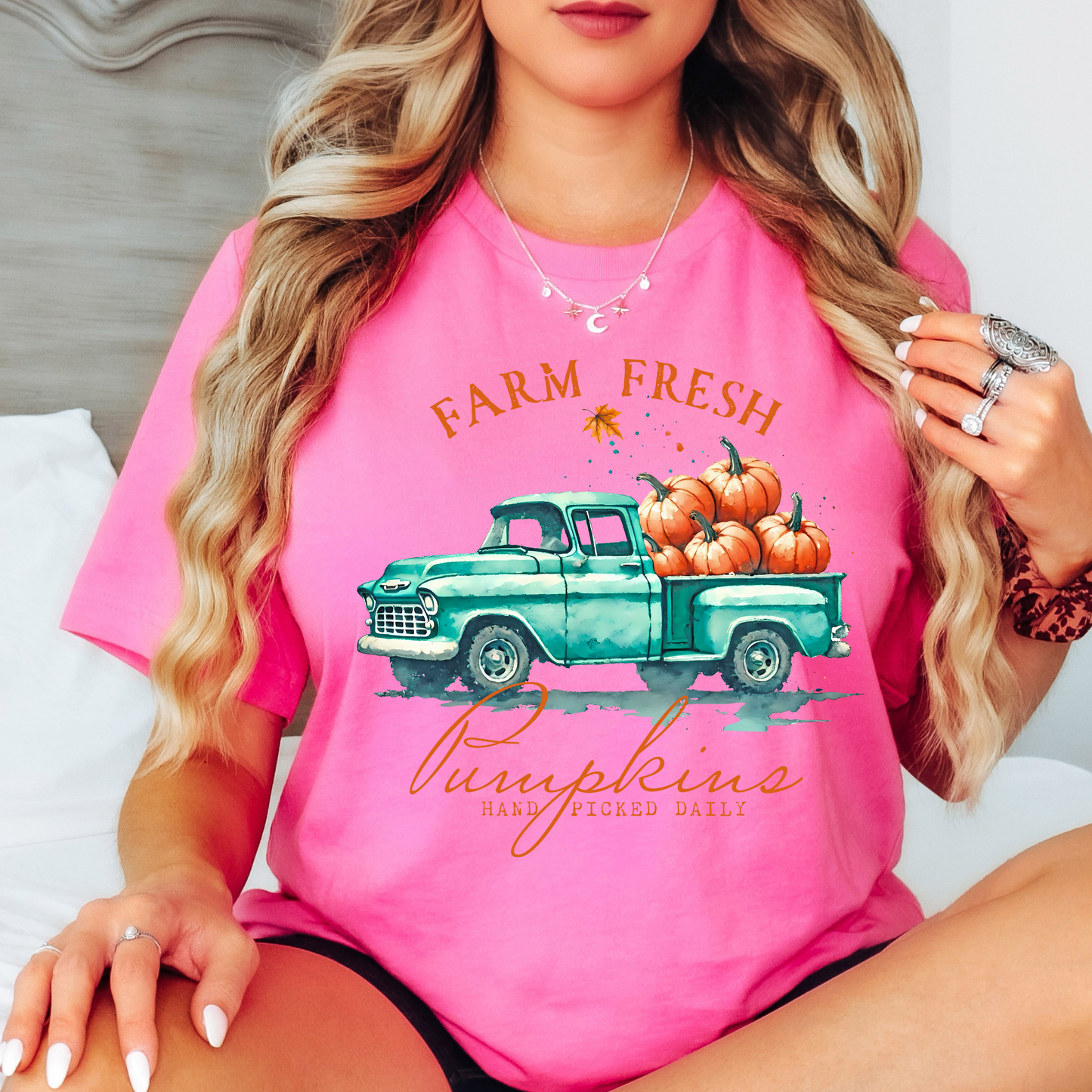 Pink t-shirt with teal truck full of pumpkins and vintage fall design

