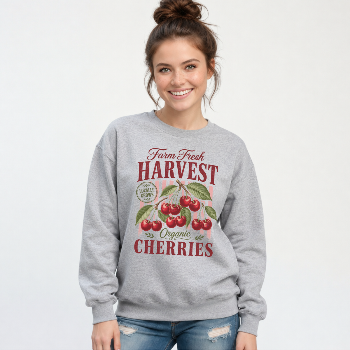 Woman wearing a sports gray Farm Fresh Harvest Cherries sweatshirt, front view on a light studio background.