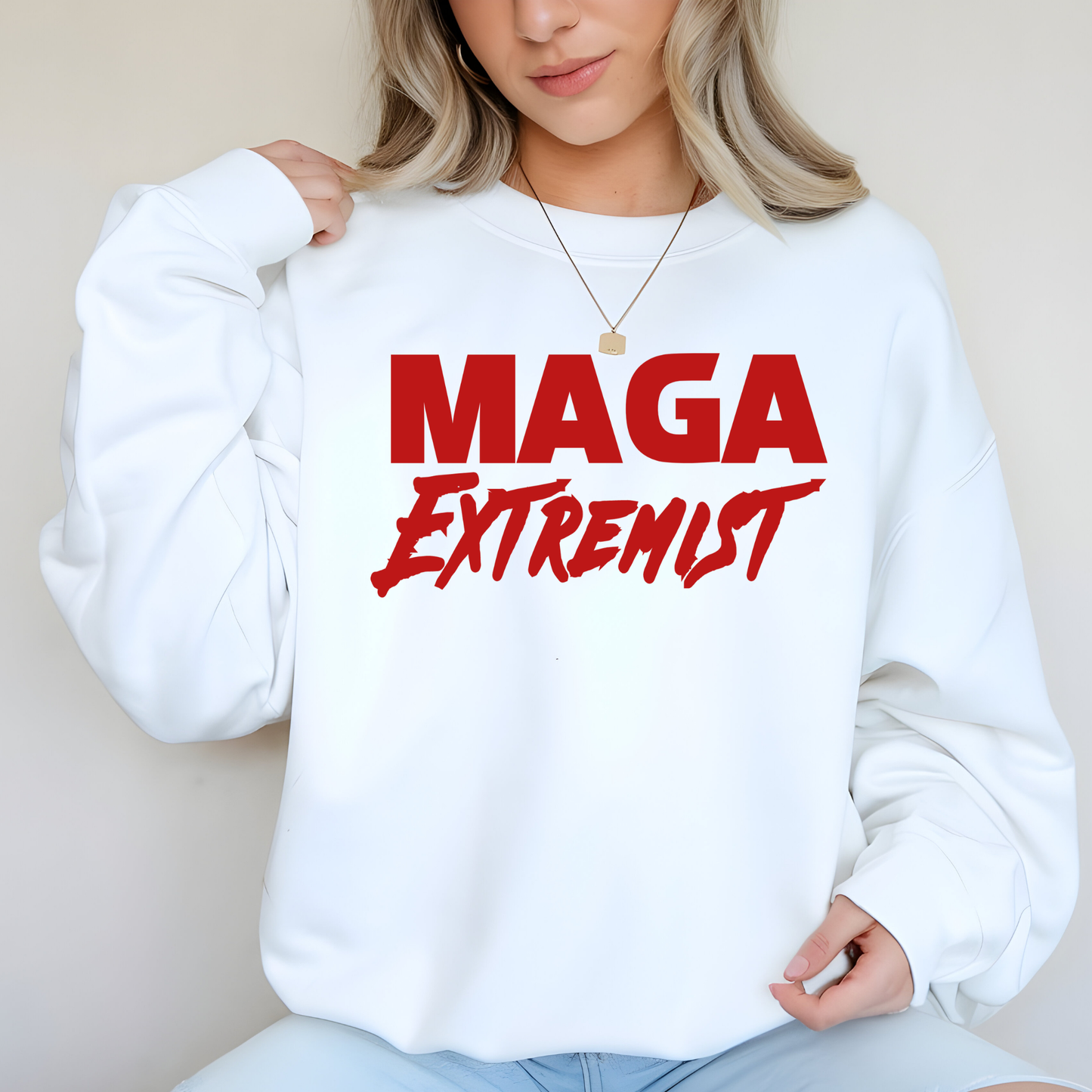Female model in white sweatshirt featuring MAGA slogan in red