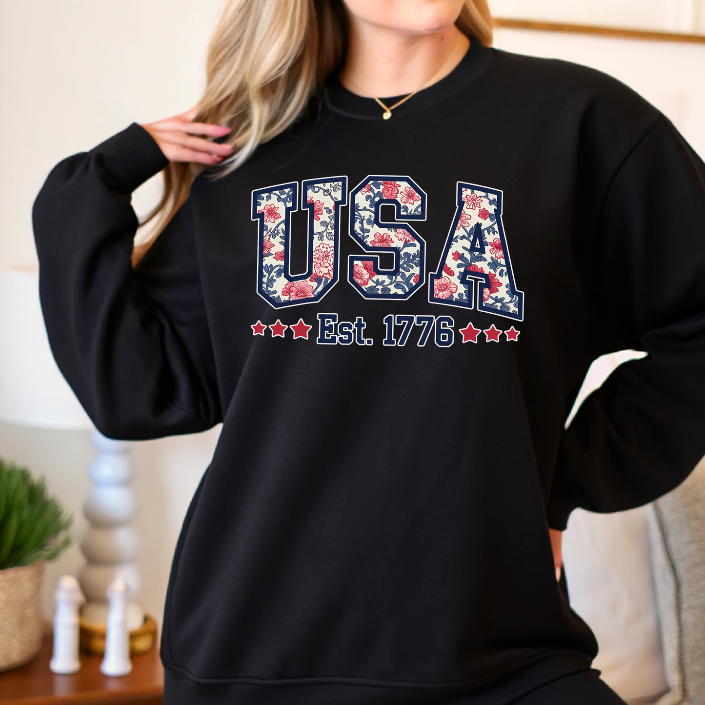 Black patriotic sweatshirt with floral USA and Est. 1776 design – women’s cozy Americana outfit.

