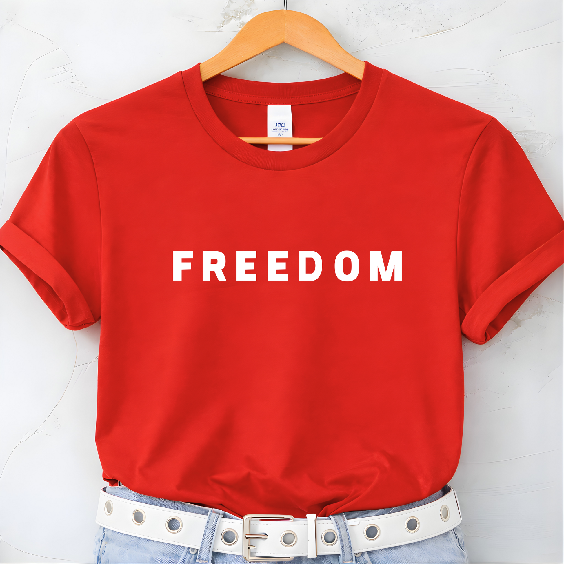 Red FREEDOM women’s t-shirt on hanger flat lay