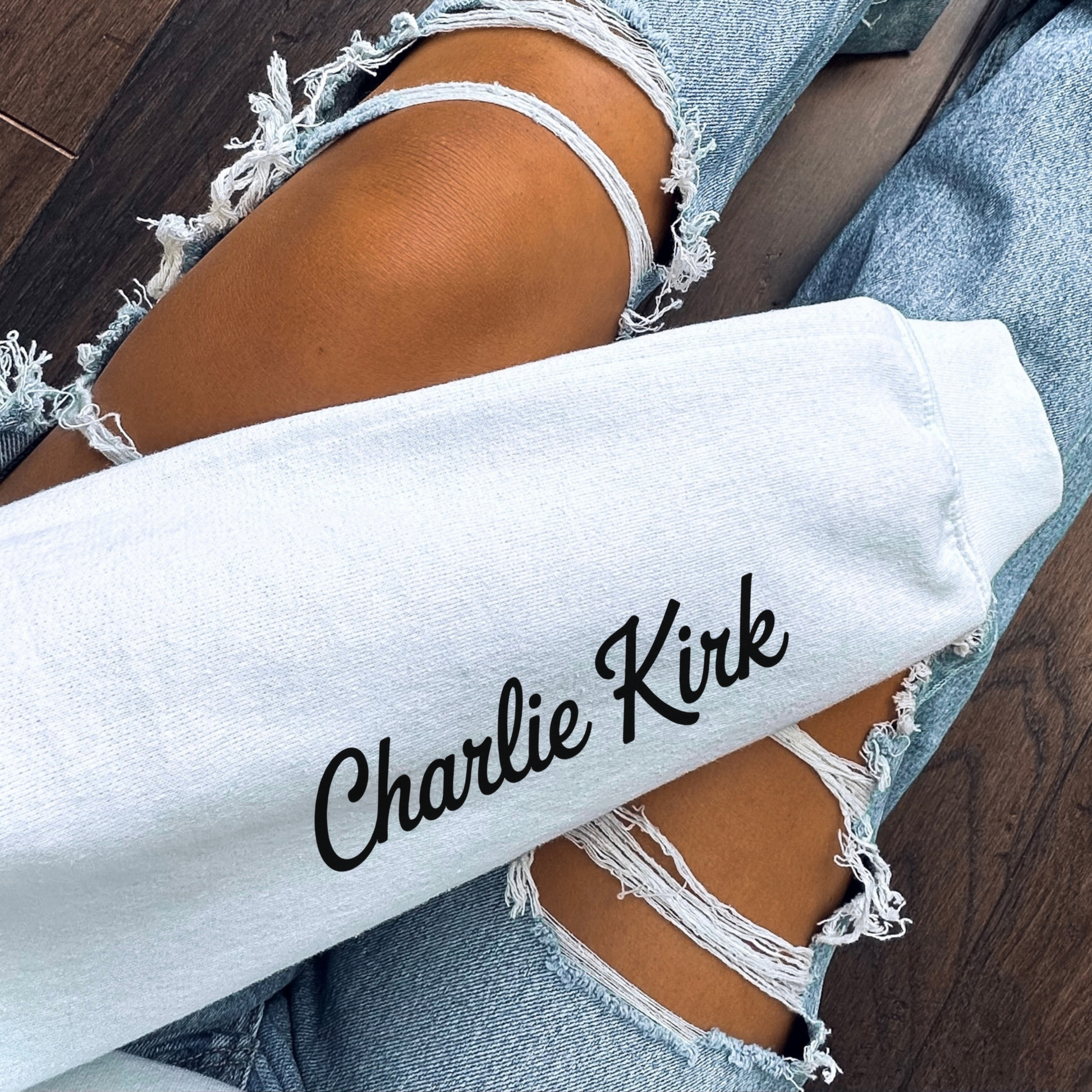 White Charlie Kirk Freedom sweatshirt sleeve close-up with tribute text