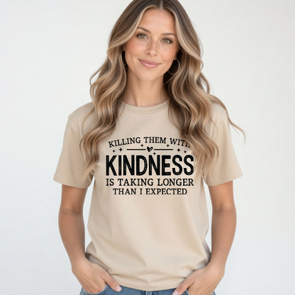 Woman modeling a sand Killing Them With Kindness T-shirt with jeans against a clean white background.