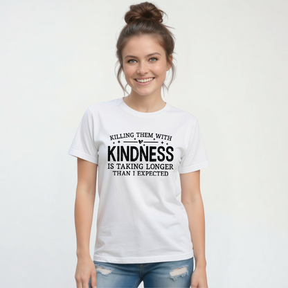 Smiling woman modeling a white Killing Them With Kindness T-shirt with distressed jeans against a white background.