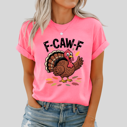 Woman wearing bright pink “F-CAW-F” turkey shirt and denim shorts
