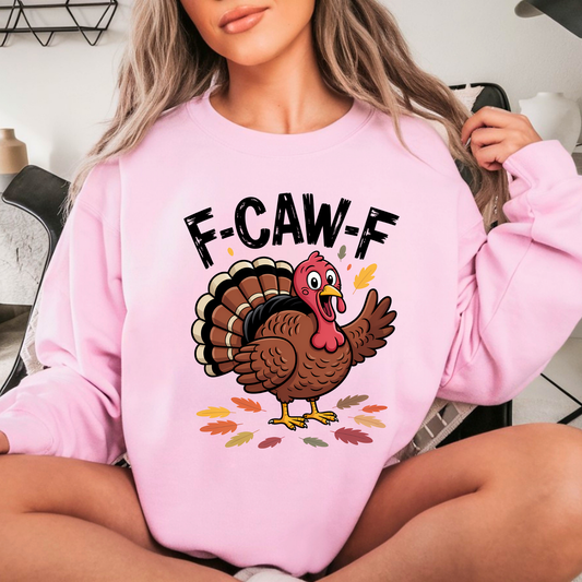 Woman wearing pink Thanksgiving crewneck with F-CAW-F turkey design