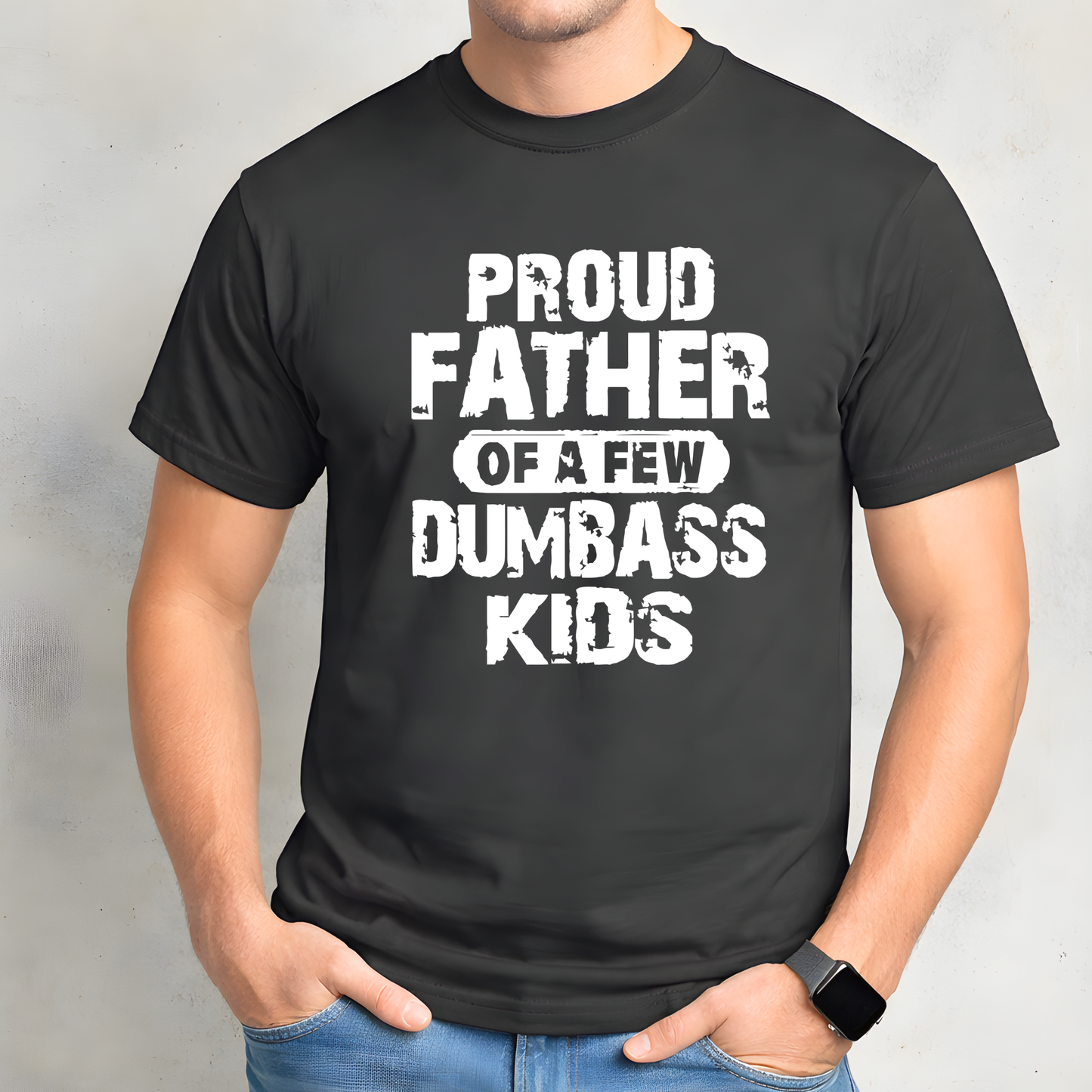 Black t-shirt with white text 'Proud Father of a Few Dumbass Kids' worn by a person on a gray background