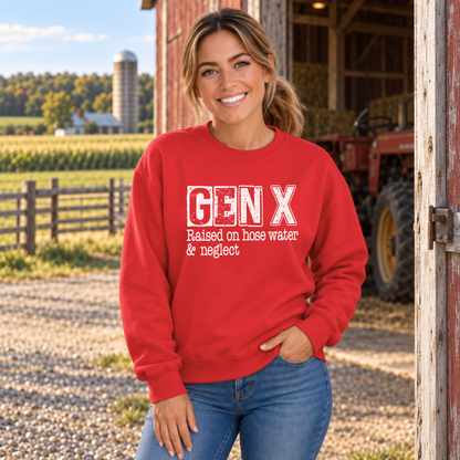 Woman wearing a red GEN X Raised on hose water & neglect sweatshirt near a barn and tractor.