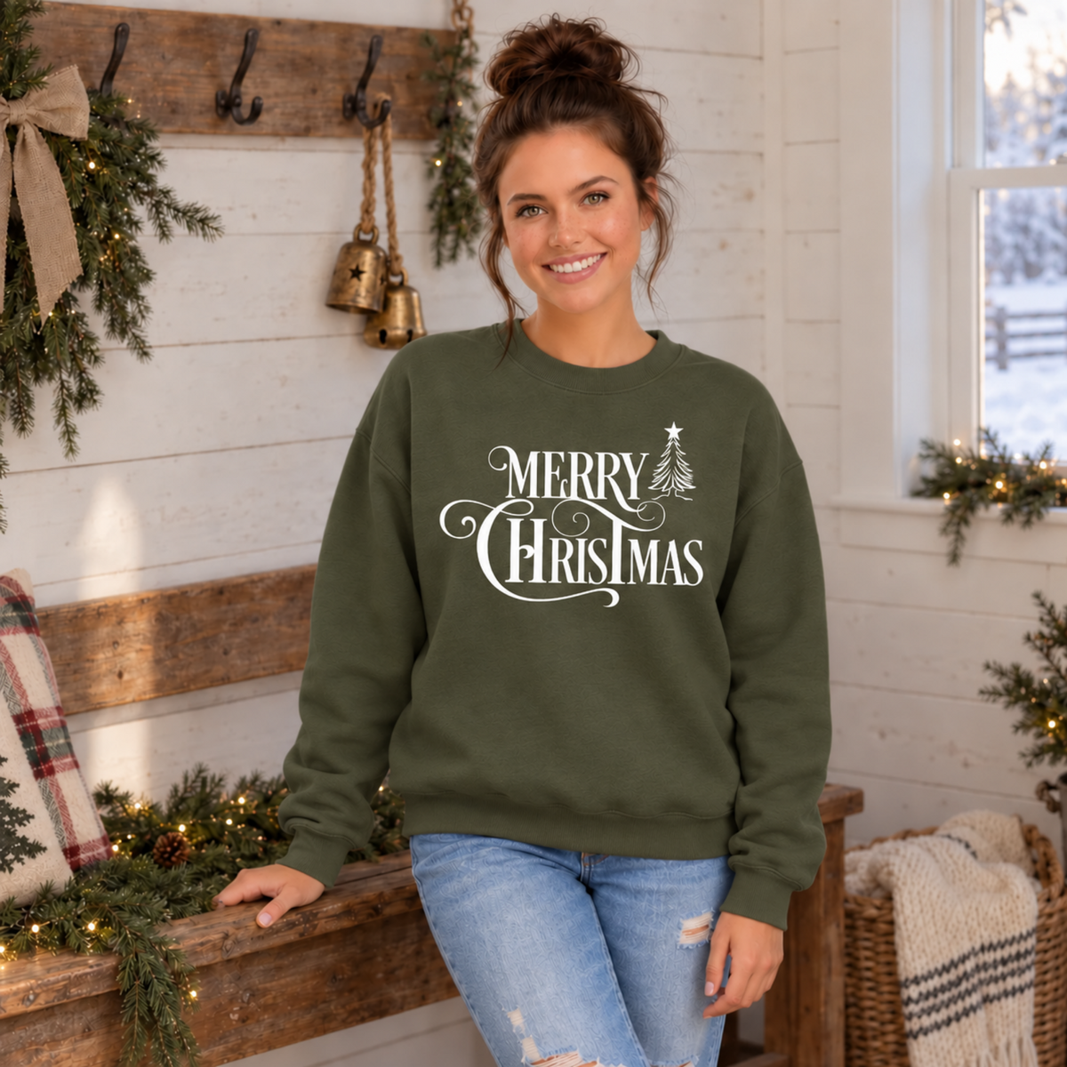 Military green Christmas crewneck sweatshirt on a model in a rustic holiday room, with white Merry Christmas artwork.