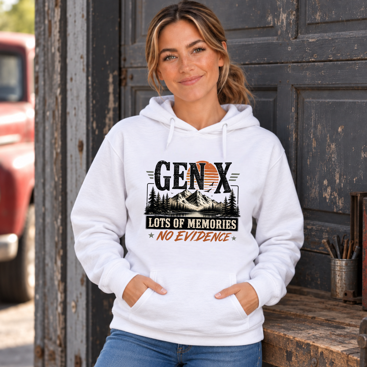 Women's white Gen X hoodie with Lots of Memories No Evidence pine tree graphic, modeled in a rustic garage