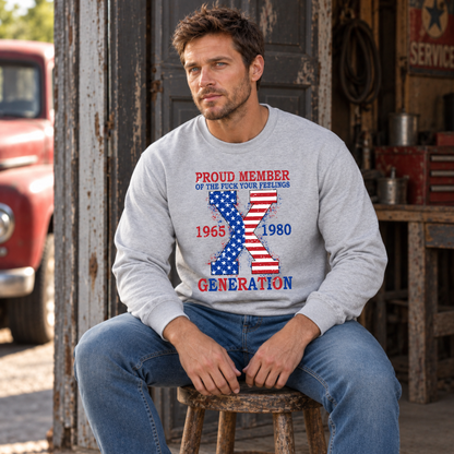Men's sports gray sweatshirt with American flag Generation X 1965–1980 design, modeled seated in a rustic garage
