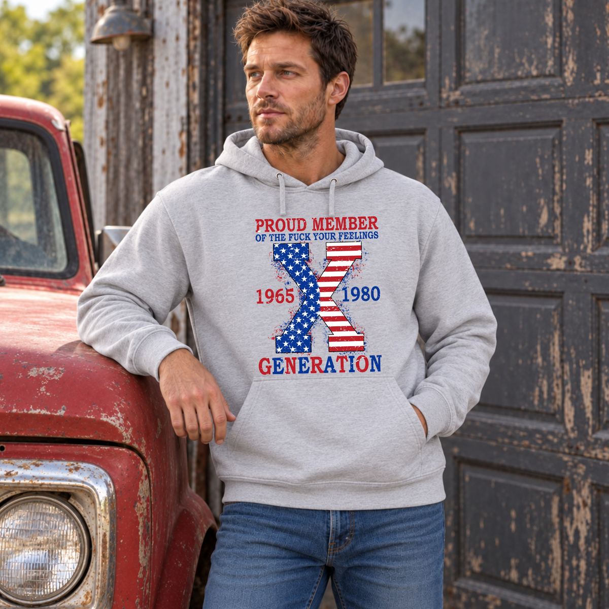 Men's sports gray hoodie with patriotic Generation X 1965–1980 graphic, modeled leaning on a vintage red truck