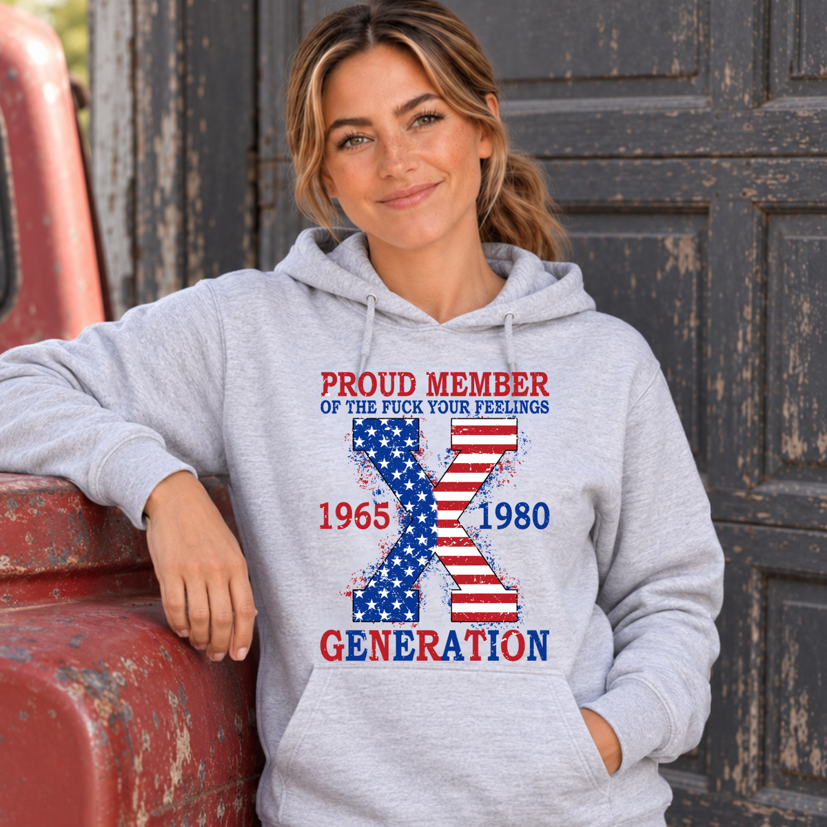Women's sports gray hoodie with American flag Generation X 1965–1980 graphic, modeled beside a vintage red truck