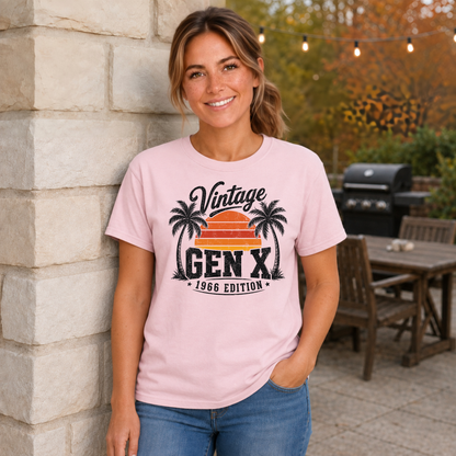 Woman wearing a light pink T-shirt with a Vintage Gen X 1966 Edition palm-tree sunset graphic in a fall patio setting.