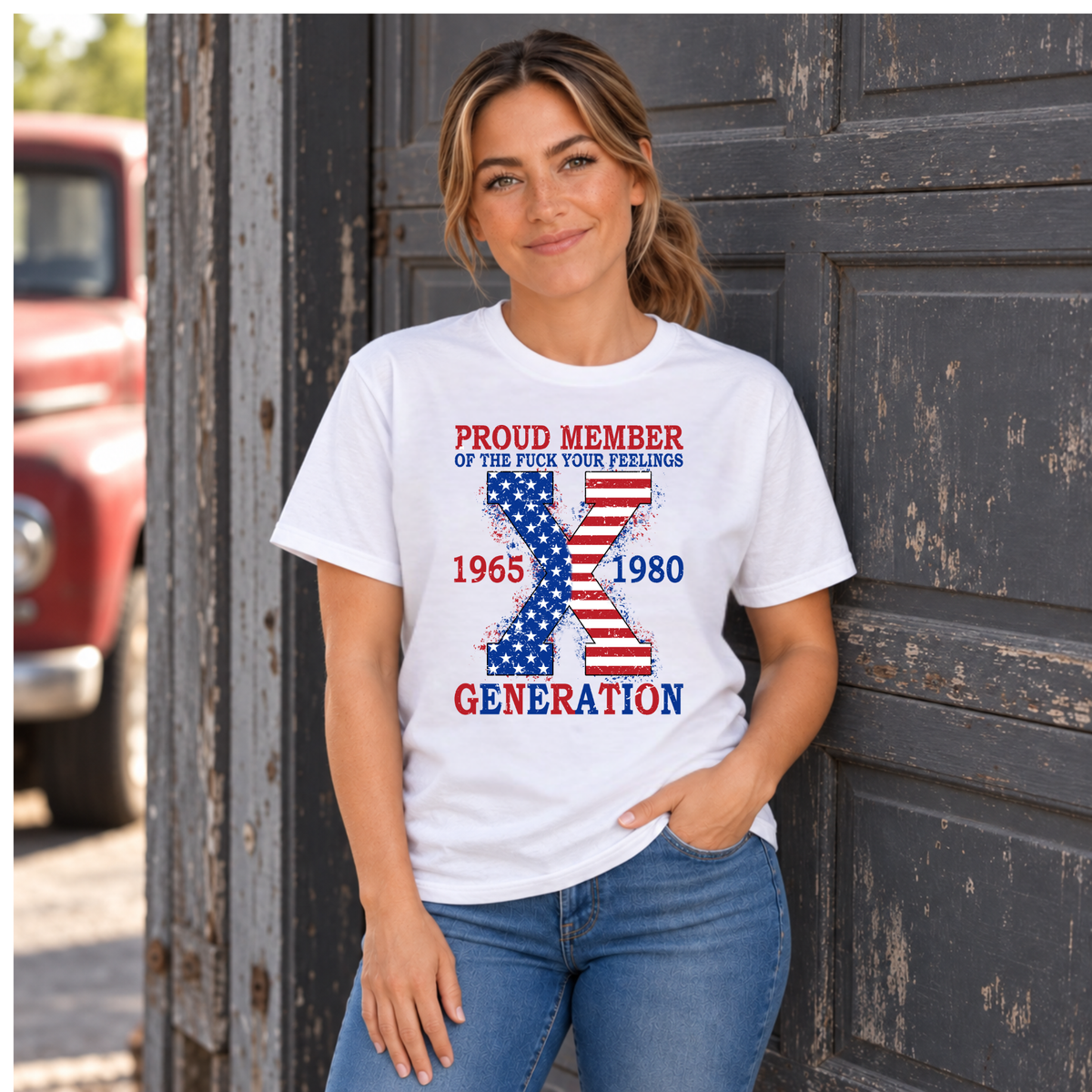 Women's white T-shirt with patriotic Generation X 1965–1980 graphic, modeled by a weathered garage door