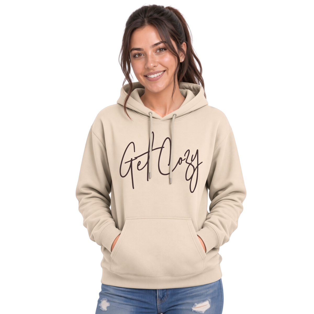 Woman wearing a sand pullover hoodie with a minimalist Get Cozy script design, paired with blue jeans on a white background.