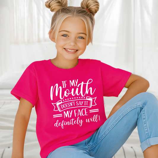 Girl in dark pink t-shirt with playful expression and quote
