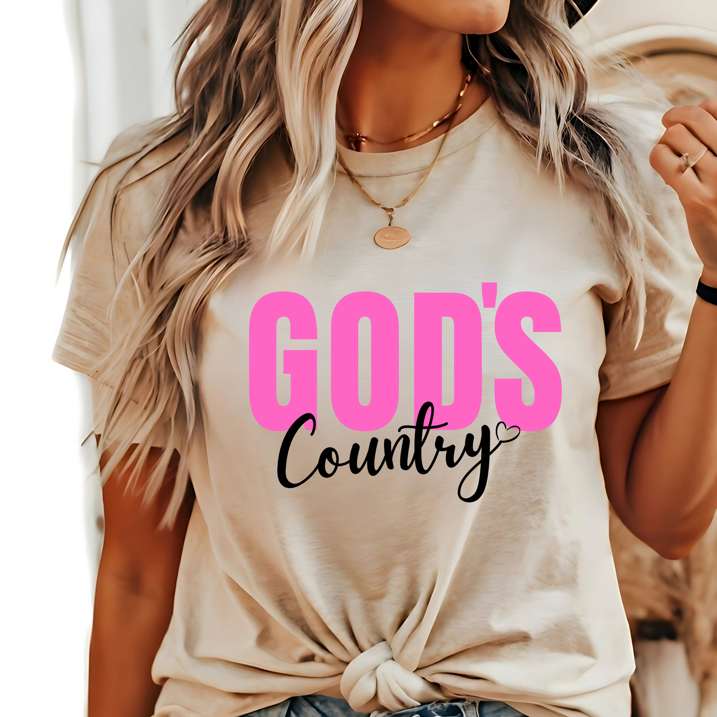Sand God's Country Christian T-shirt with pink and white text, perfect for patriotic believers who love faith-based apparel