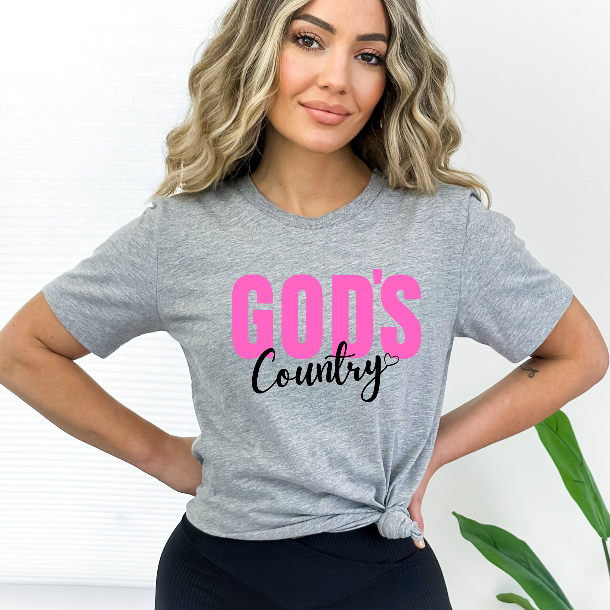 Gray God's Country Christian T-shirt with pink and white text, perfect for patriotic believers who love faith-based apparel