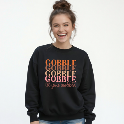 Woman modeling a black crewneck sweatshirt with the retro “Gobble Gobble Gobble Gobble til you wobble” Thanksgiving design against a clean white background.