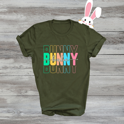 Trendy Bunny Babe graphic t-shirt with colorful pastel typography, perfect for Easter outfits, spring fashion, and casual wear. Soft cotton tee for women.